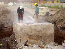 massive reinforced concrete being drilled before bustar grout breaks the concrete